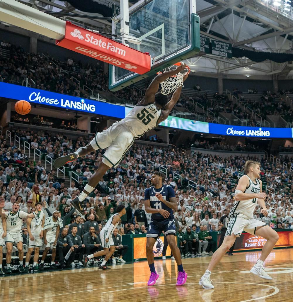 <p>MSU sophomore forward Coen Carr (55) dunks during their season opener against Monmouth University at the Breslin Center on Nov. 4, 2024.</p>