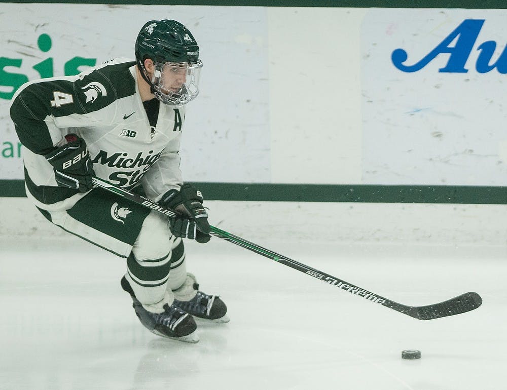 <p>Then junior defender Travis Walsh skates with the puck Feb. 14, 2015, during the game against Penn State at Munn Ice Arena in East Lansing. The Nittany Lions were defeated by the Spartans, 3-2. Emily Nagle/The State News</p>