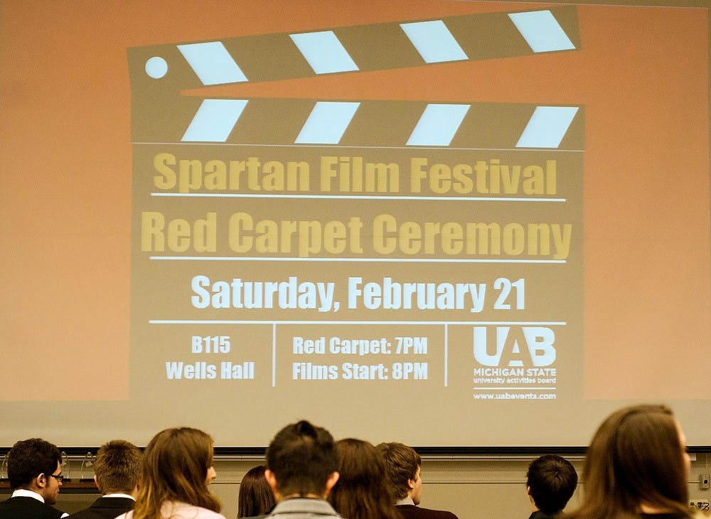 <p>Students sit in seats and wait to watch a film Feb. 21, 2015, during the Spartan Film Festival at Wells Hall. Students walked the red carpet prior to viewing various films directed by students. Alice Kole/The State News</p>