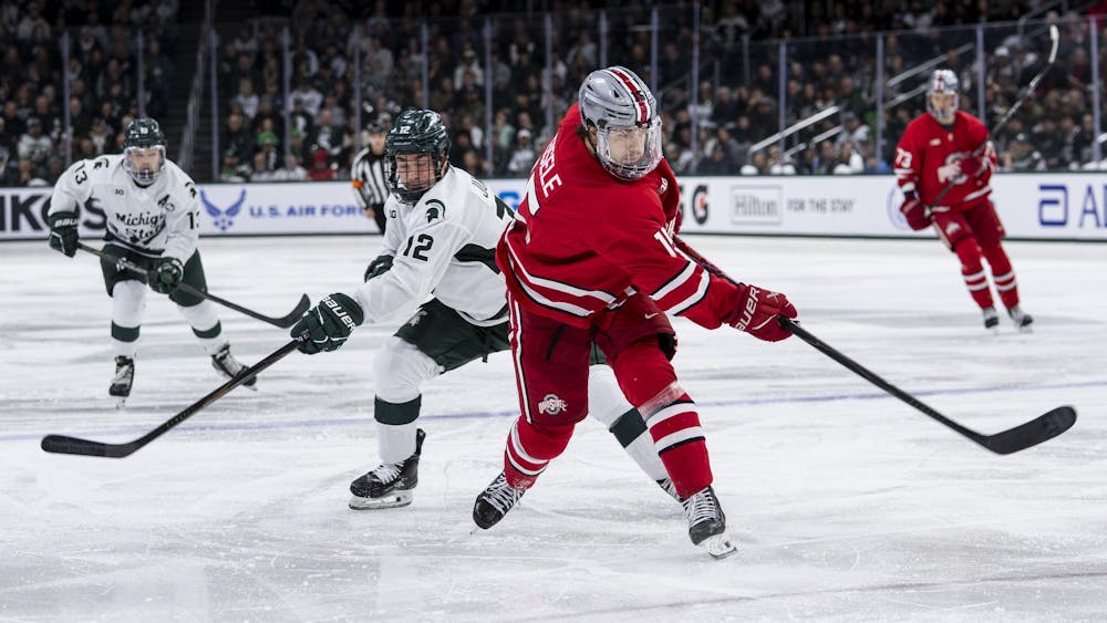 <p>OSU graduate forward Adam Eisele (15) and MSU junior forward Griffin Jurecki (12) fight for the puck in the Munn Ice Arena on March 14, 2026.</p>