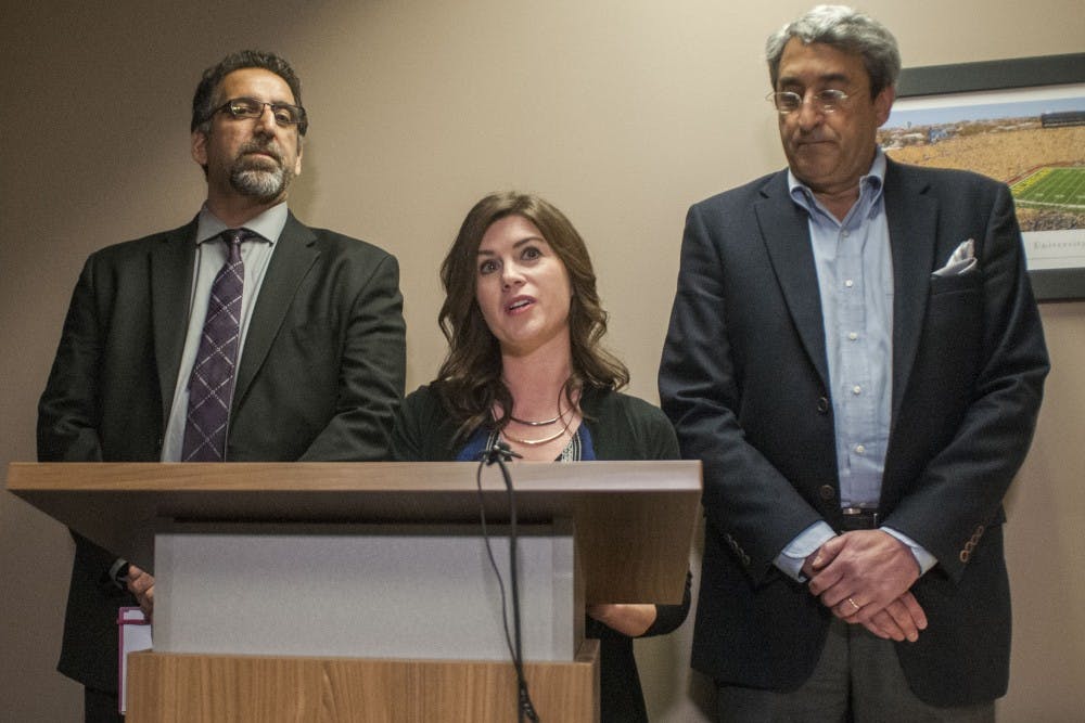 Lansing resident Larissa Boyce, center, gives a statement about former MSU employee Larry Nassar on March 24, 2017 at Church Wyble P.C. at 2290 Science Parkway in Okemos. Boyce, a former MSU gymnast sexually abused by Nassar, has decided to dismiss anonymity in order to encourage change and challenge stigma. "When your house is robbed, you come forward. Well, our bodies were robbed," Boyce said. 