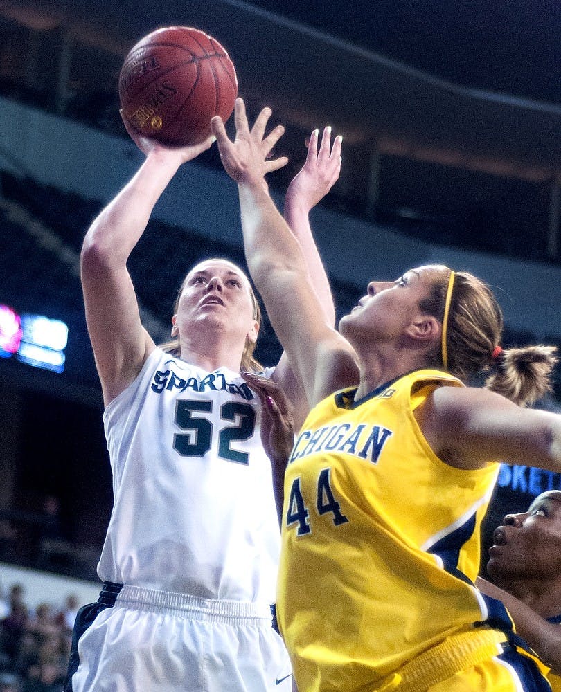 Sophomore forward Becca Mills shoots as Michigan center Rachel Sheffer blocks during the quarterfinals of the Big Ten Tournament against Michigan on March 8, 2013, at Sears Centre in Hoffman Estates, Ill. The Spartans defeated the Wolverines 62-46. Julia Nagy/The State News