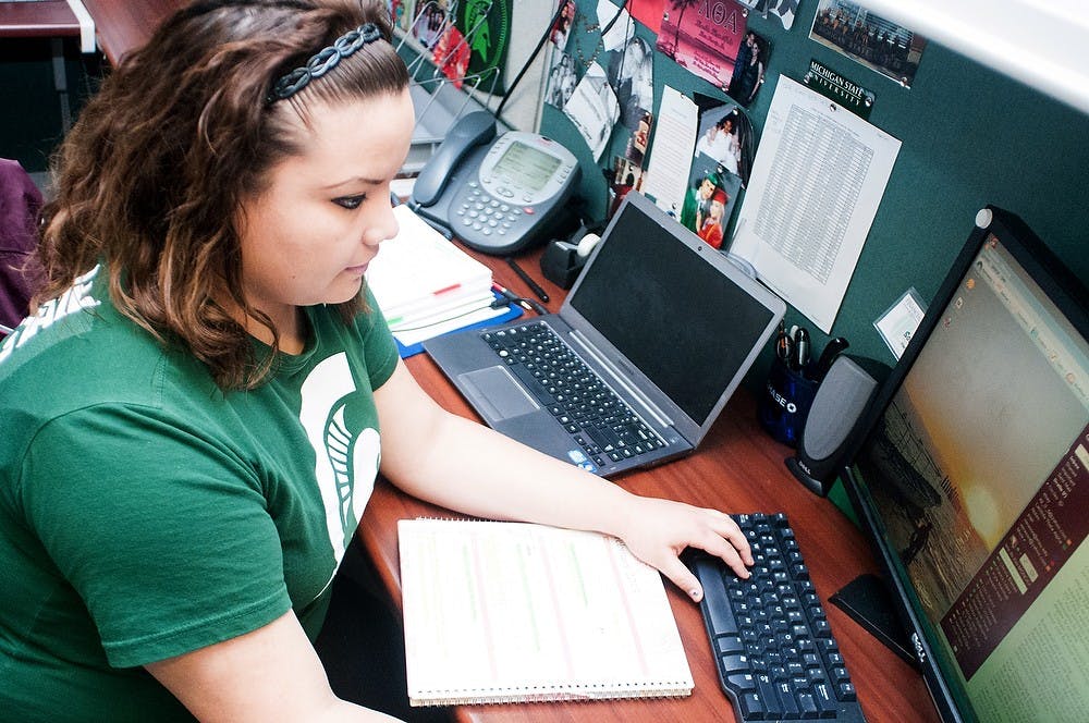 	<p>Food industry management senior Sonia Viera sits at her desk while working Feb. 4, 2013, at Student Services.  Viera works in the Office of Financial Aid as a student advisor. Katie Stiefel/The State News</p>
