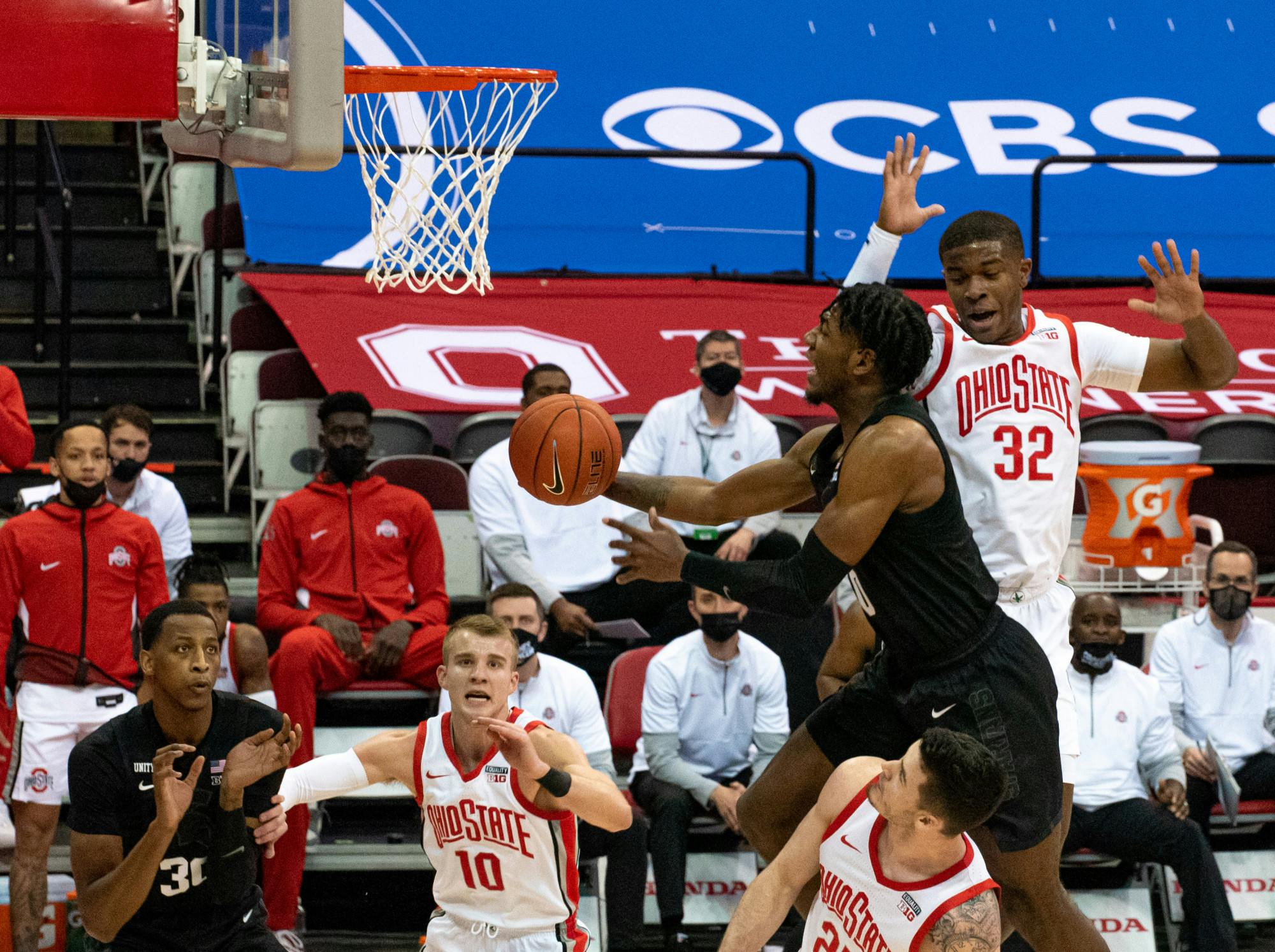 <p>Aaron Henry (0) takes a leap towards Ohio State&#x27;s basket in the first half but is unsuccessful. The Buckeyes swept the Spartans 79-62 at OSU&#x27;s Schottenstein Center on Jan. 31.</p>