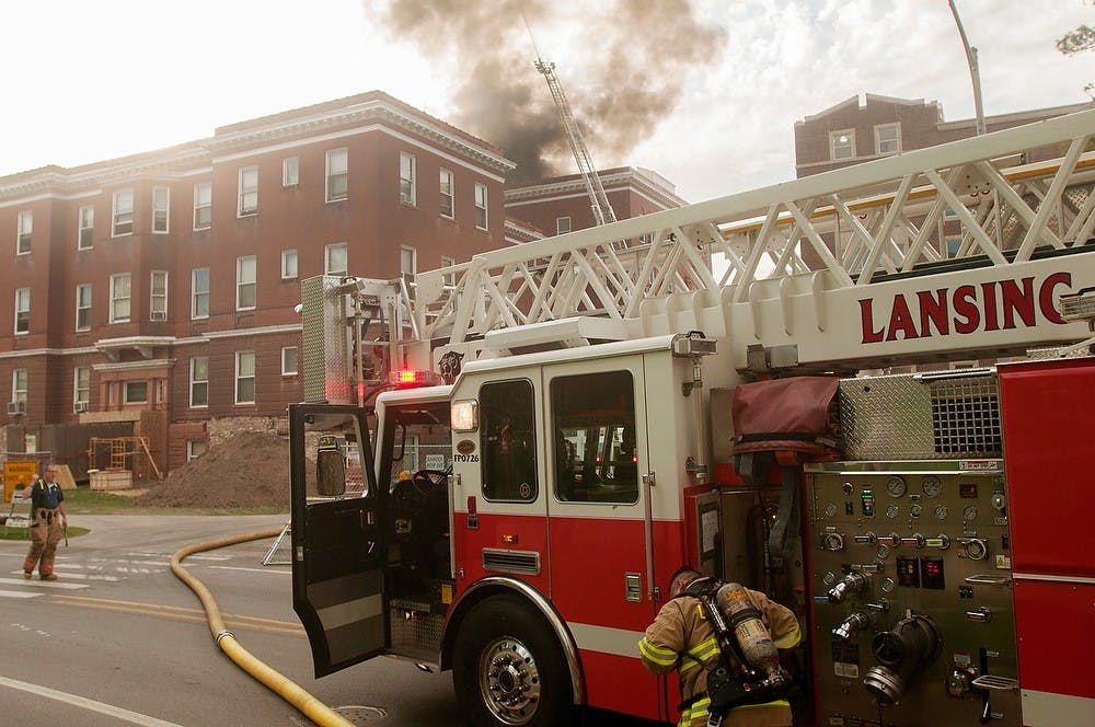 	<p>Fire fighters prepare to put out the fire May 15, 2013, at Morrill Hall. No explosions have been reported according to observers. Weston Brooks/The State News</p>