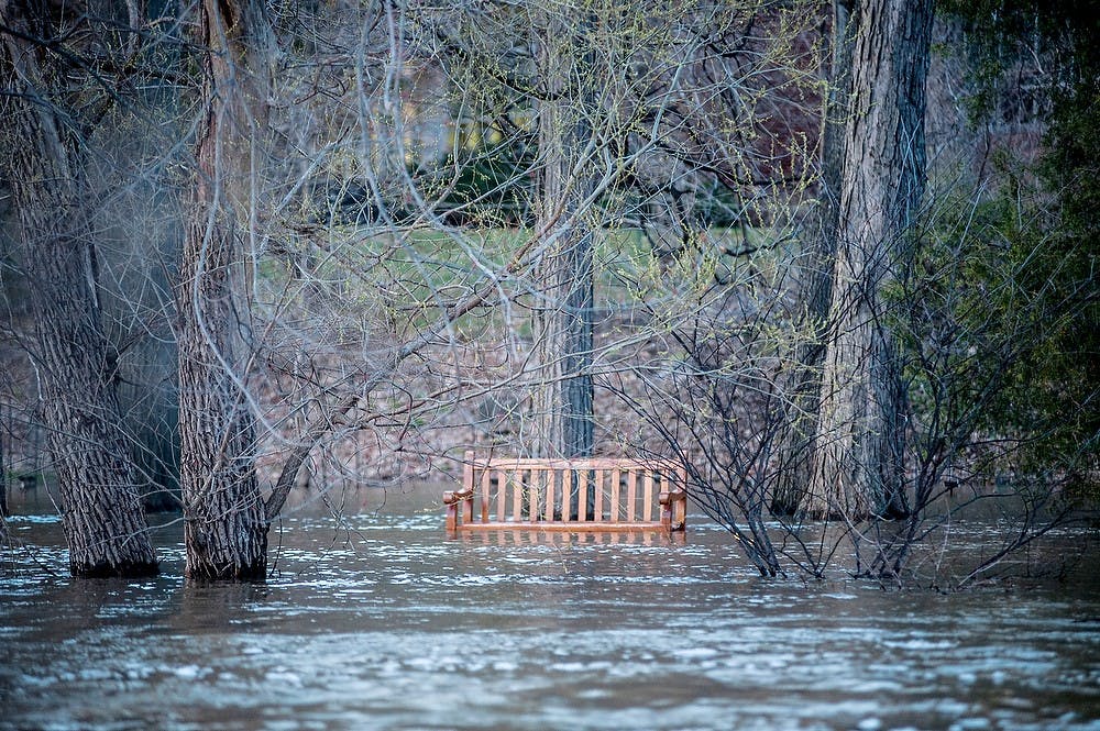 	<p>The water level of the Red Cedar River rose above 7 feet, flooding part the bank from the Main Library to Kellogg Center, April 20, 2013. Justin Wan/The State News</p>