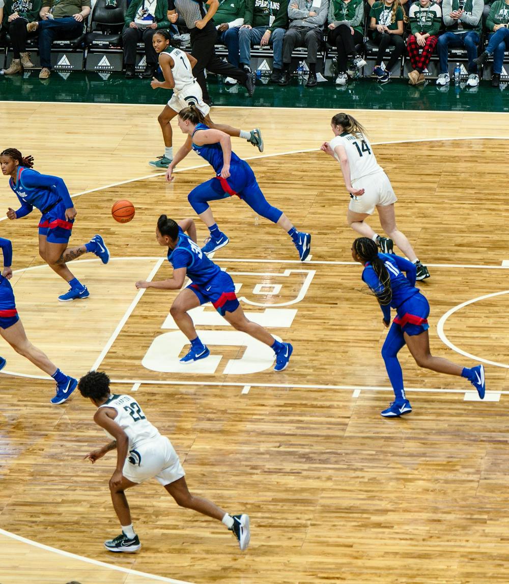 DePaul graduate student forward Jorie Allen (33) takes the ball down the court at the Breslin Center on Dec. 8, 2024. The Spartans won 89-61 against the Blue Demons, starting the season 9-0 for the first time in program history. 