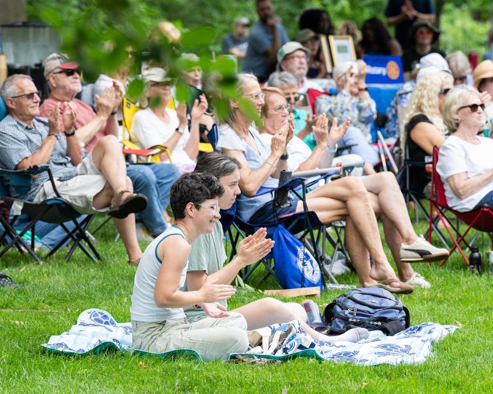 <p>The crowd claps as the MSU Go Music Trio finishes a song during the Music and the Garden event in East Lansing, Mich., on June 28, 2026.</p>