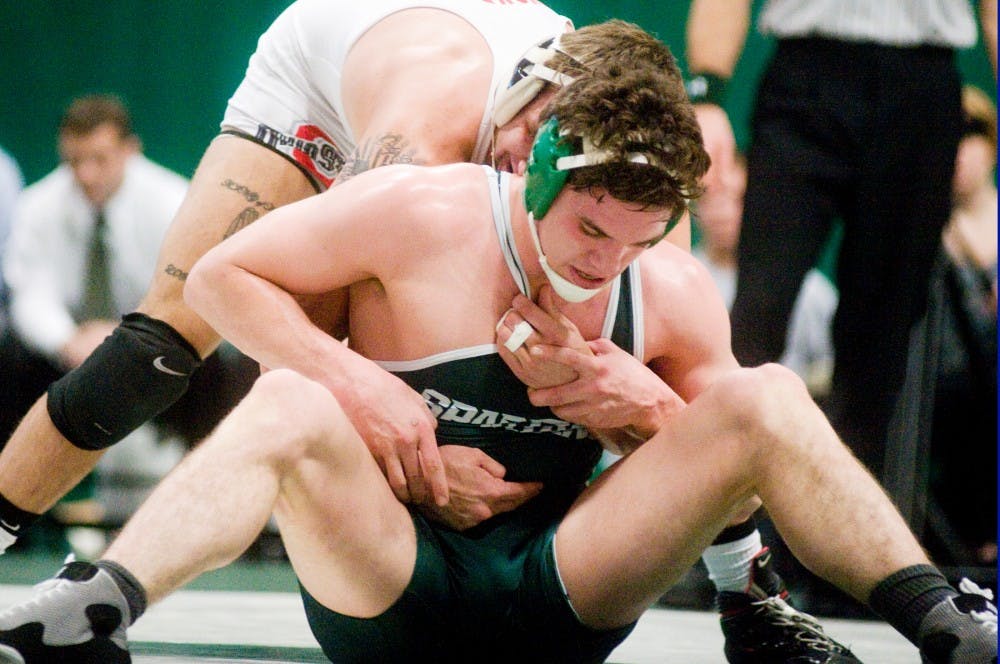 Senior 174-pounder Curran Jacobs struggles to stay in a neutral position with Buckeye sophomore Nick Heflin. The Spartans fell to the Buckeyes 24-13 Sunday afternoon at Jension Field House. Anthony Thibodeau/The State News