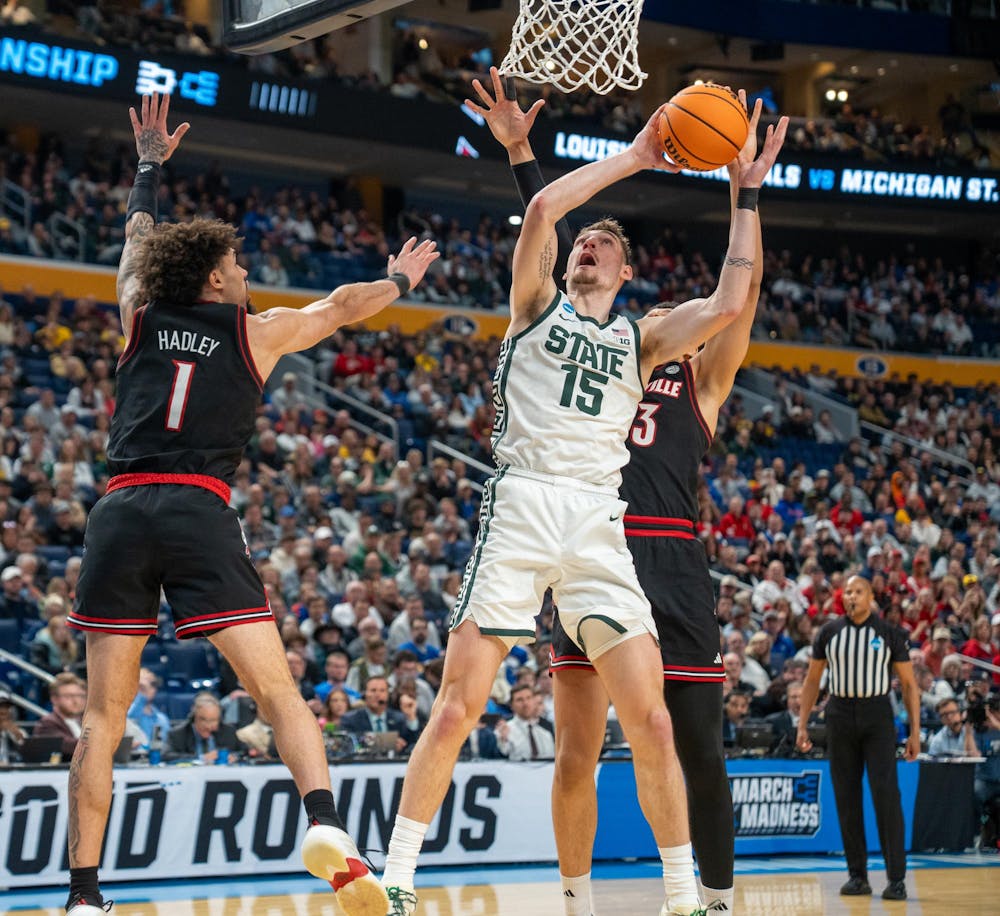 Senior center Carson Cooper (15) goes up for a shot during the March Madness matchup against University of Louisville at the KeyBank Center in Buffalo, New York on March 21, 2026.