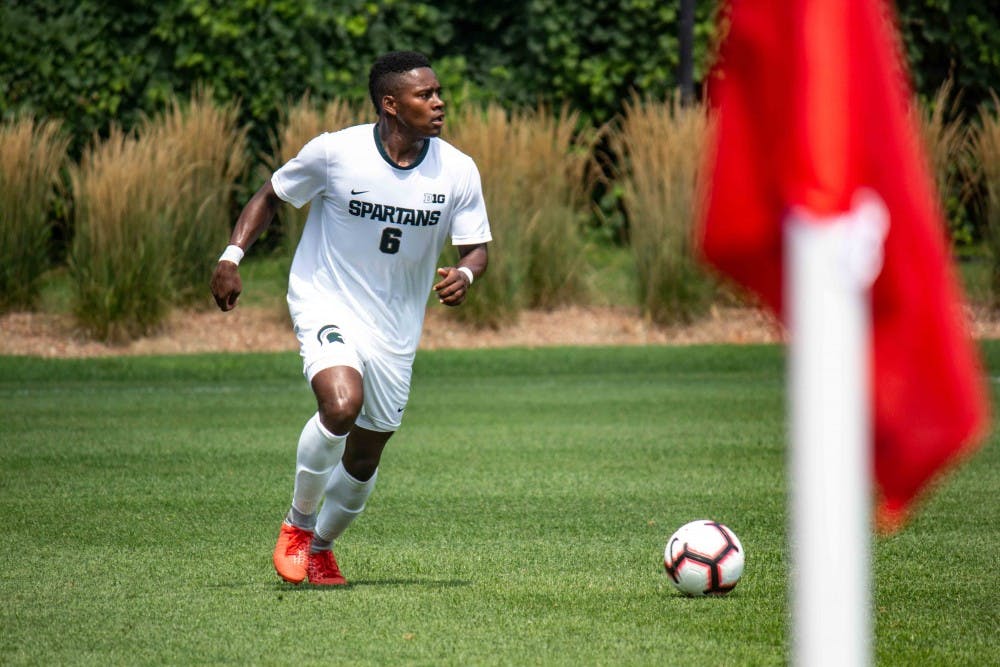 <p>Senior forward DeJuan Jones (6) dribbles the ball during the exhibition match against Western Michigan on Aug. 13, 2018 at DeMartin Soccer Stadium. The Spartans tied with the Broncos, 1-1.</p>