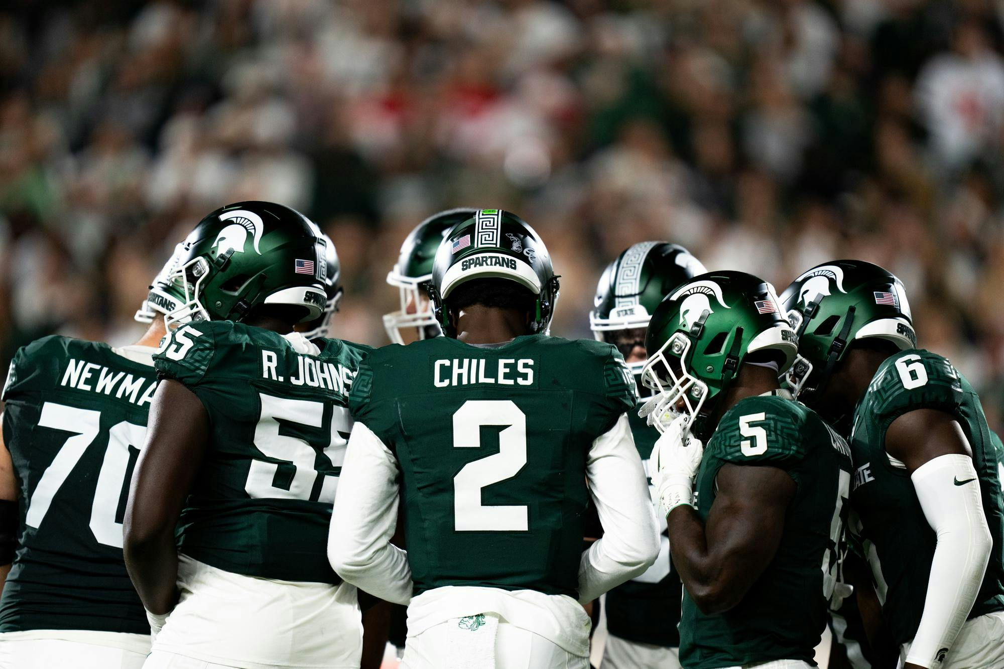 Michigan State sophomore quarterback No. 2 Aidan Chiles leads his team in a huddle during a game against the Ohio State Buckeyes at Spartan Stadium, Sept. 28, 2024.