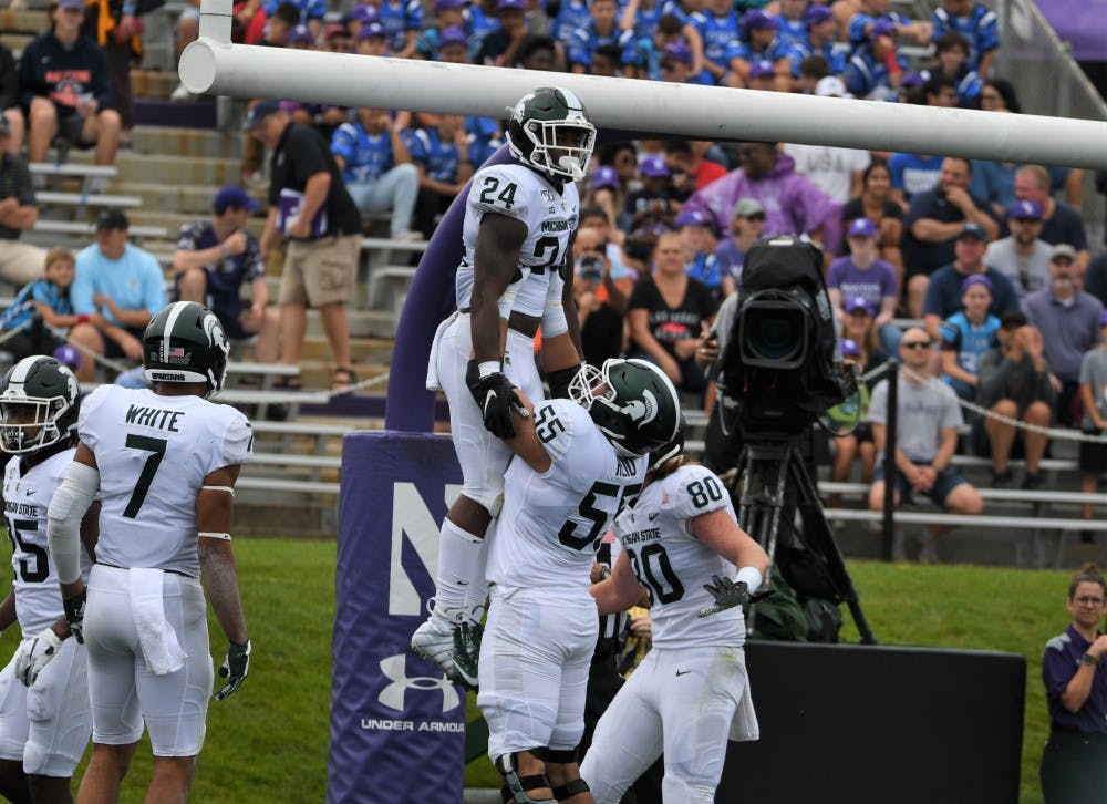 <p>Redshirt freshman tailback Elijah Collins (24) celebrates a touchdown during the game against Northwestern at Ryan Field on Sept. 21, 2019. MSU defeated Northwestern 31-10.</p>