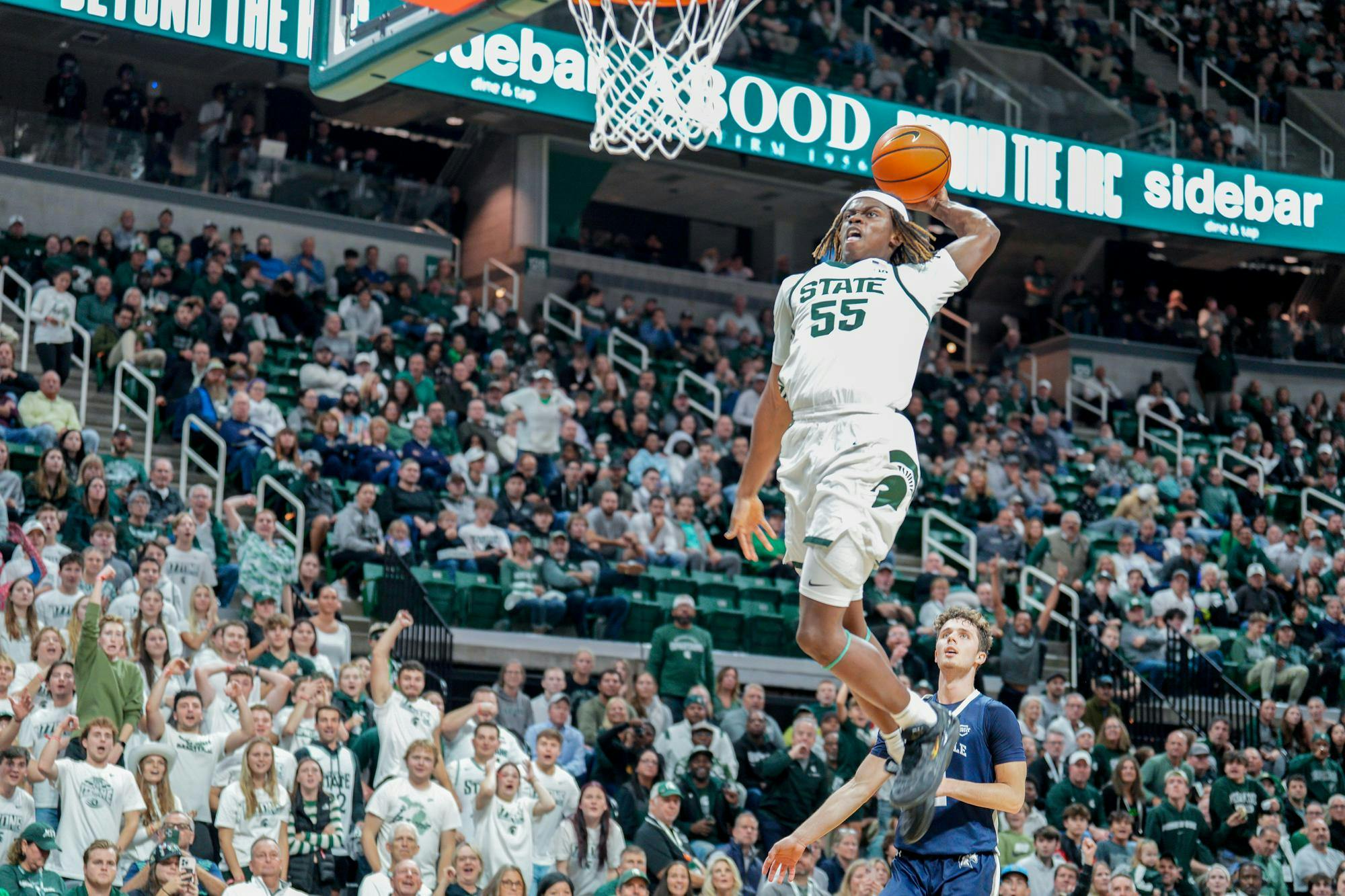 <p>Freshman forward Coen Carr (55) dunks the ball during a game against Hillsdale at the Breslin Center on Oct. 25, 2023. The Spartans defeated the Chargers 85-43. </p>