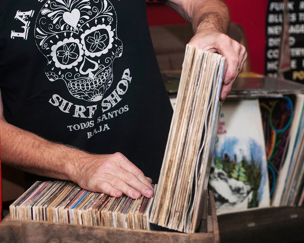 	<p>Owner Dave Bernath picks up a handful of records from a crate on Oct. 31, 2013, at Flat, Black &amp; Circular, 541 East Grand River Ave. Flat, Black and Circular has been operating for the past 36 years. Georgina De Moya/The state News</p>