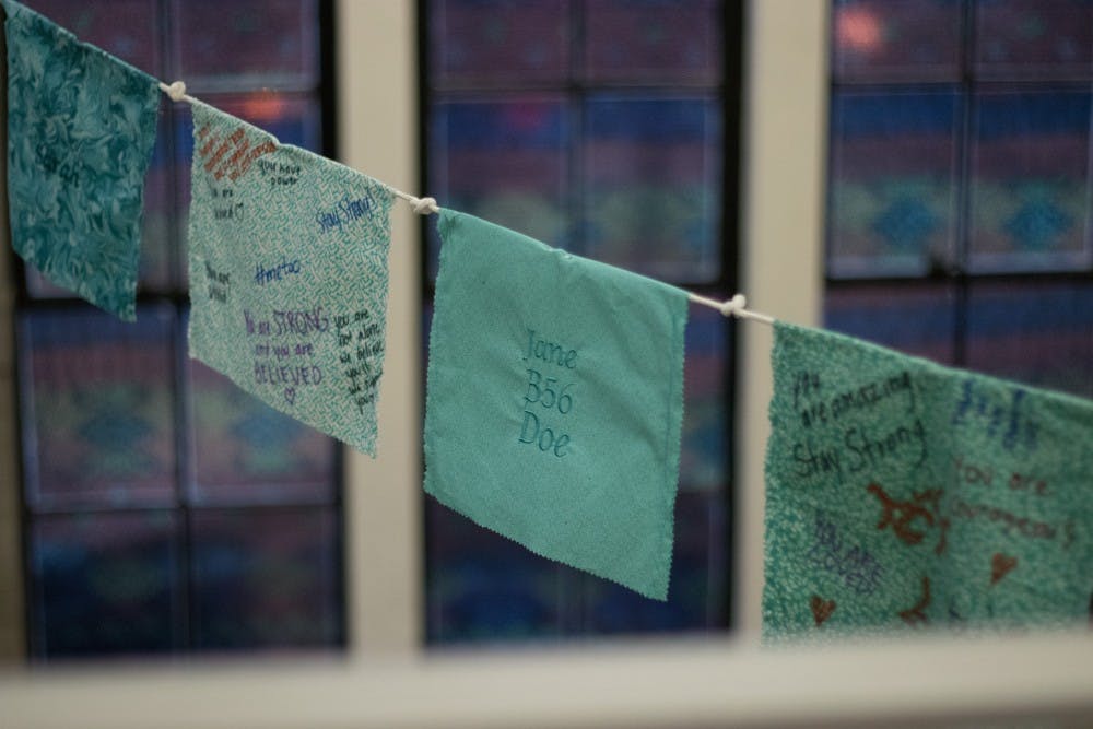 Tibetan prayer flags hang in the MSU Museum on Jan. 15, 2019. These symbolize support for sexual assault and abuse survivors.