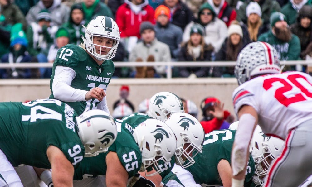 <p>Redshirt freshman quarterback Rocky Lombardi (12) looks down the offensive line during the game against Ohio State Nov. 10, 2018. The Spartans fell to the Buckeyes, 26-6.</p>