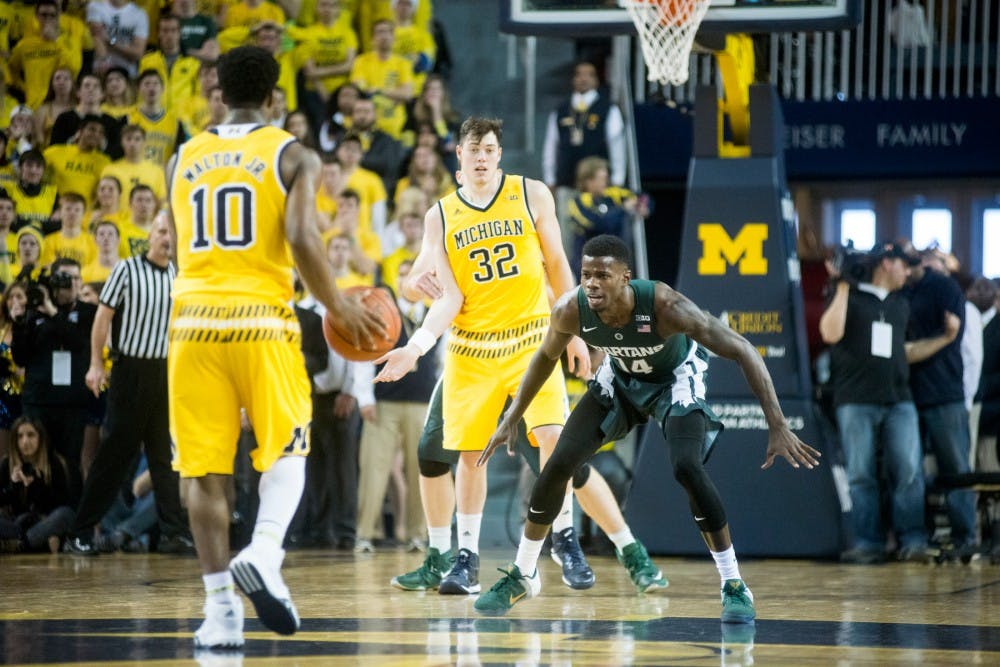 Junior guard Eron Harris prepares to defend Michigan guard Derrick Walton Jr. during the game against Michigan at Crisler Center in Ann Arbor on Feb. 6, 2016.  The Spartans defeated the Wolverines, 89-73.