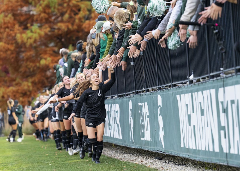 The Spartans high-five their fans after winning their game against the Minnesota Golden Gophers, 2-1, on Sunday, Oct. 30, 2022 at DeMartin Stadium. 