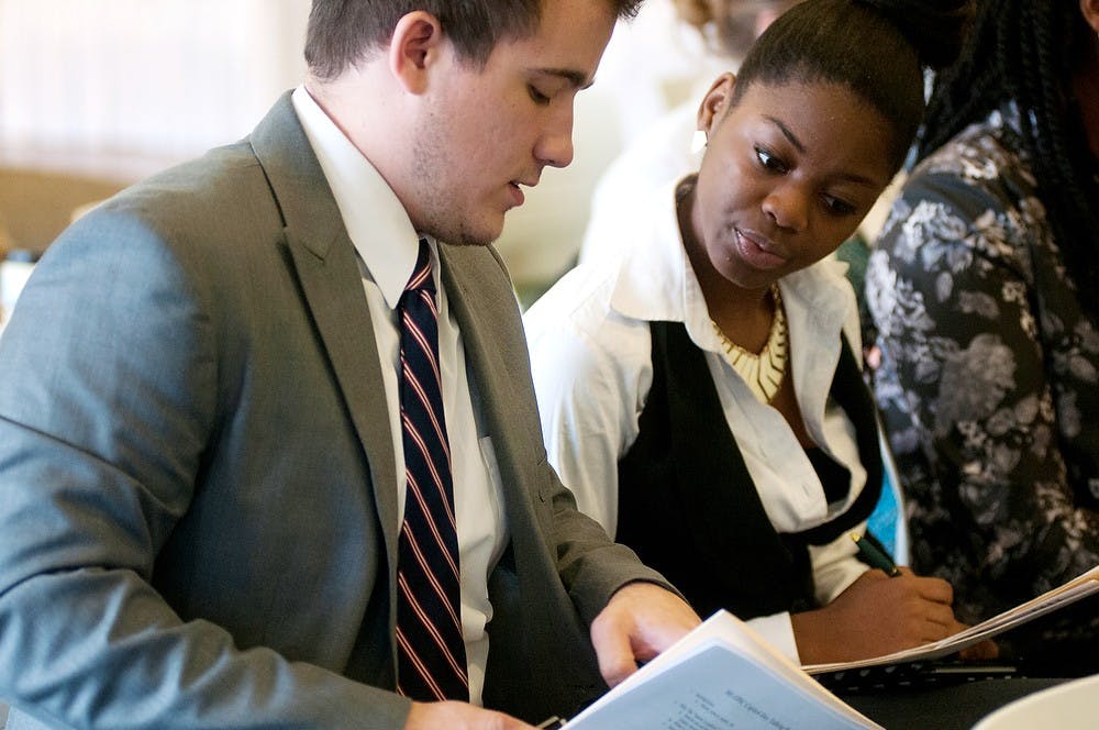 <p>Kalamazoo, Mich., residents Tyler Sauer, left, and Chiante Lymon participate in a workshop on how to meet with representatives on Nov. 12, 2014 at Case Hall. Mi-EPIC had a lobby day to advocate for the intern protection bill. Aerika Williams/The State News </p>
