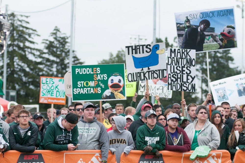 <p>Fans watch the big screen on Sept. 12, 2015, at ESPN's College Gameday at Munn field. Hundreds of students arrived early in the morning for a chance to see the live taping. Jack Stephan/ The State News</p>