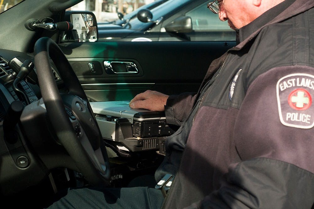 <p>East Lansing Police Department senior officer Todd Quick organizes equipment Jan 28, 2015, in his new Ford Police Interceptor at the East Lansing Police Department, 409 Park Lane in East Lansing. Kennedy Thatch/The State News</p>