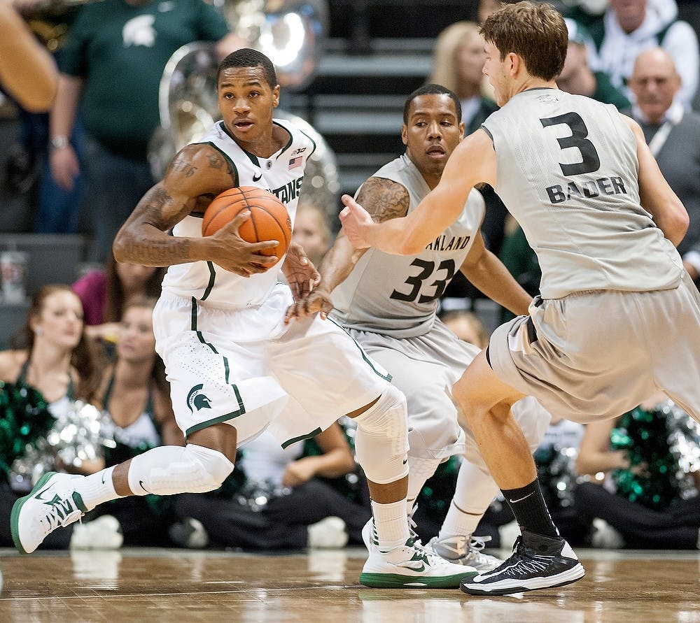 	<p>junior guard Keith Appling tries to keep possession with Oakland guards Ryan Bass, No. 33, and Travis Bader in defense. The Spartans defeated the Golden Grizzlies, 70-52, Friday, Nov. 23, 2012, at Breslin Center. Justin Wan/The State News</p>