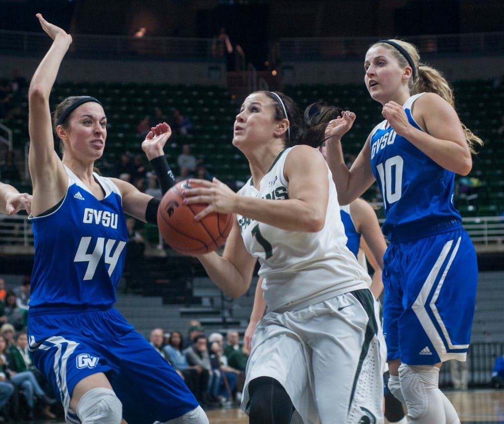 <p>Sophomore guard Tori Jankoska goes for a layup while  Grand Valley center Korynn Hincka and Grand Valley guard Taylor Lutz attempt the block during the game against Grand Valley State on Nov. 9, 2014, at the Breslin Center. The Spartans defeat the Lakers 70-51. Raymond Williams/The State News</p>