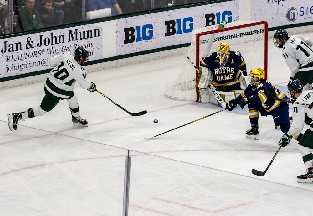Senior forward Sam Saliba shoots the puck against Notre Dame.The Spartans lead the Fighting Irish, 1-0, after two periods at Munn Ice Arena. 