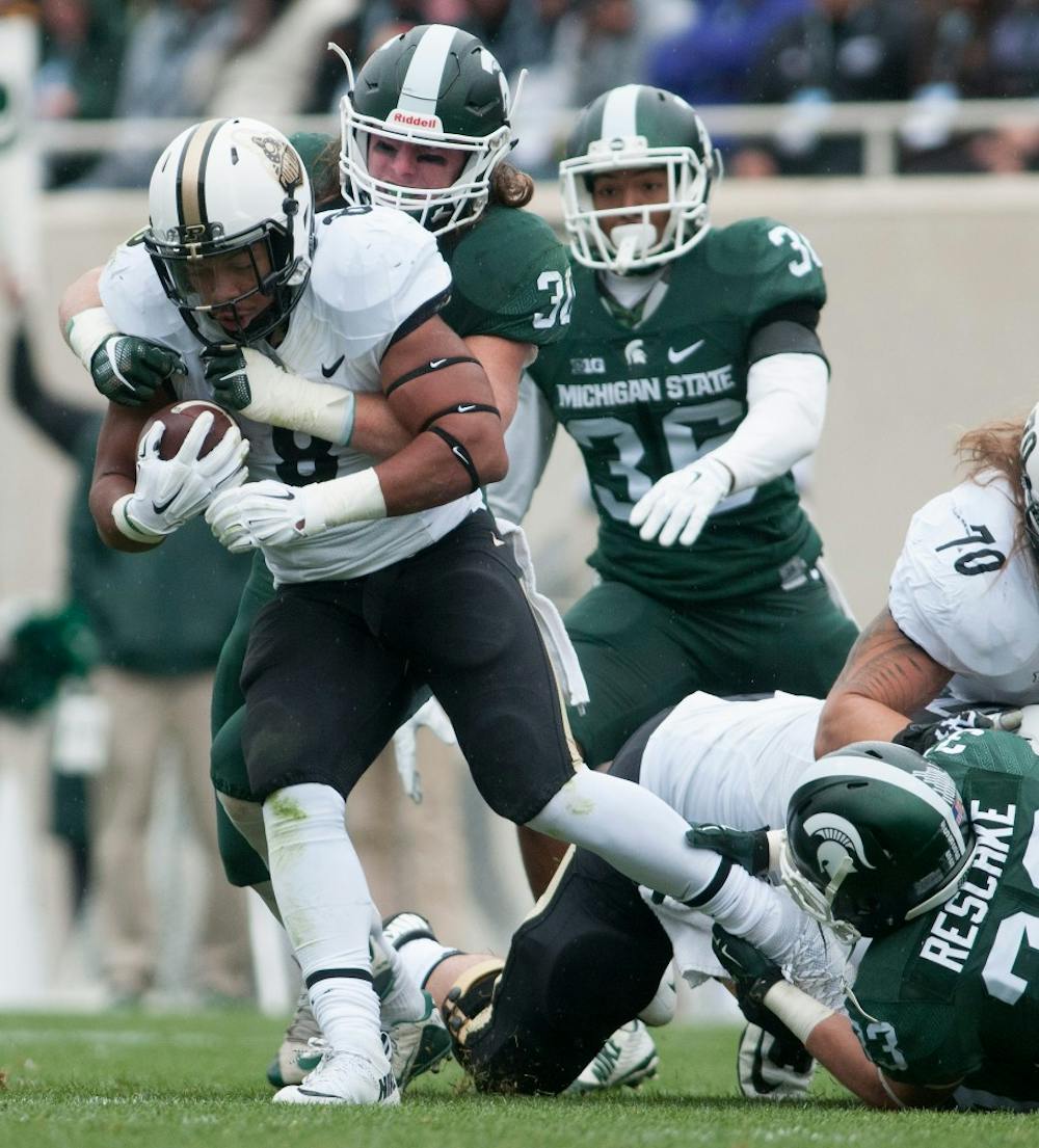 <p>Junior linebacker Riley Bullough tackles Purdue running back Markell Jones in the first quarter during the Homecoming game against Purdue on Oct. 3, 2015 at Spartan Stadium. The Spartans defeated the Boilermakers, 24-21.</p>