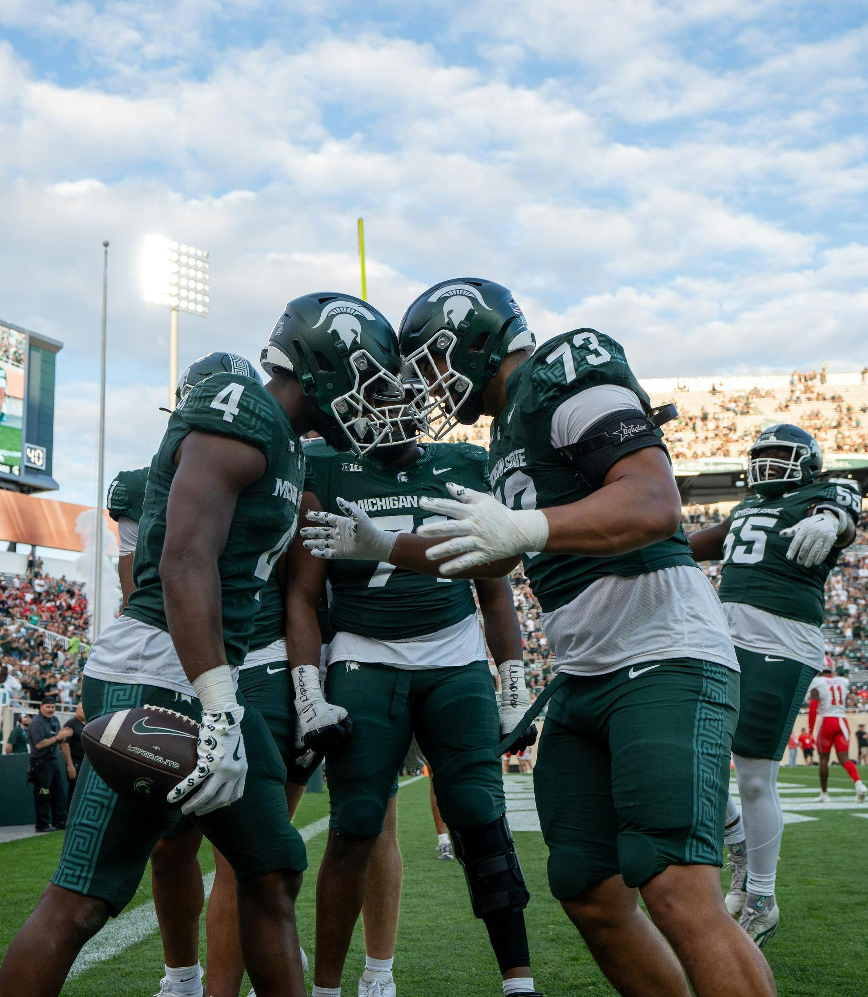 <p>MSU redshirt senior running back Elijah Tau-Tolliver (4) celebrates a touchdown with teammates during the game against Youngstown State at Spartan Stadium in East Lansing, Michigan on Sept. 13, 2025.</p>