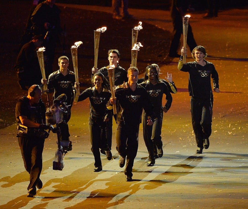 Seven young athletes carry the Olympic torch in Olympic Stadium during the Opening Ceremony for the London 2012 Summer Olympic Games in London, England, Friday, July 27, 2012. (David Eulitt/Kansas City Star/MCT)