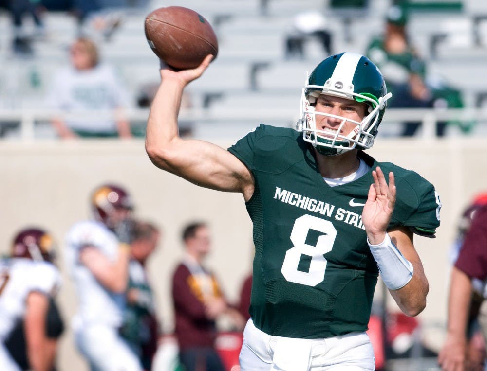 Senior quarterback Kirk Cousins throws a pass in warmups before the game Saturday at Spartan Stadium. Matt Radick/The State News