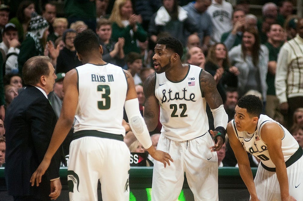 <p>Head coach Tom Izzo converses with sophomore guard Alvin Ellis III, 3, senior forward Branden Dawson, 22, and senior guard Travis Trice during the game against Maryland on Dec. 30, 2014, at Breslin Center. The Spartans were defeated by the Terrapins, 68-66 in double overtime. Danyelle Morrow/The State News</p>