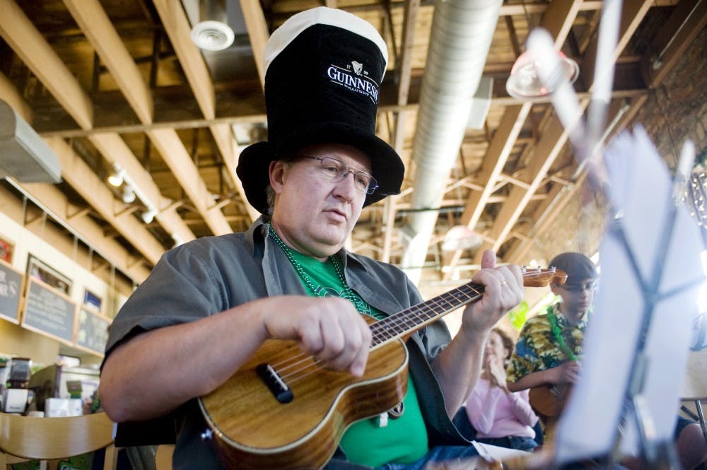 Mark Horning, of Hartland, Mich. plays the Irish folk song Whiskey in the Jar with his ukulele Saturday morning at Sir Pizza Grand Cafe, of 201 East Grand River Avenue, Lansing. The Lansing Area Ukulele Group or L.A.U.G.H. meets once per month and join in for a ukulele jam. Justin Wan/The State News
