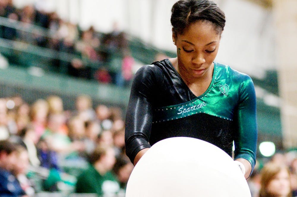 Redshirt sophomore Taira Neal prepares to compete on the uneven parallel bars at the gymnastics meet against Pittsburgh on Saturday night at Jenison Field House. The Spartans defeated Pittsburgh 193.875-193.475. Jaclyn McNeal/The State News