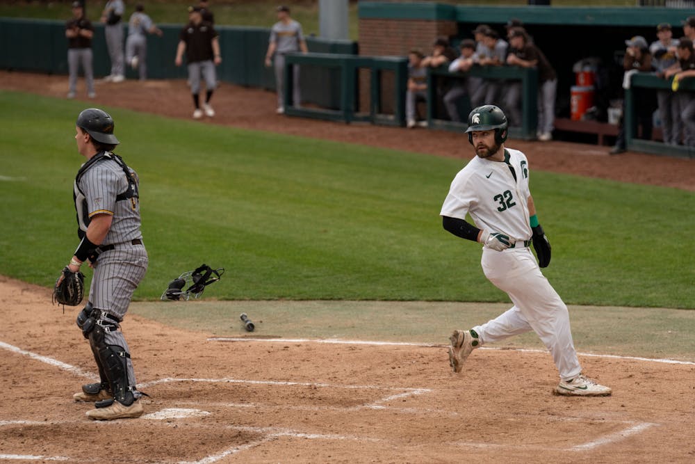 <p>Senior Zach Iverson watches as his teammate also scores a run just a couple of seconds after him. MSU would end up losing to Western Michigan 18-7 on April 13, 2022. </p>
