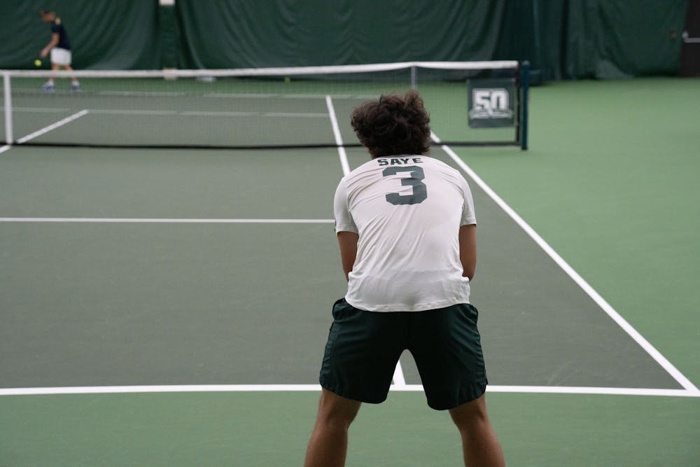 <p>Freshman David Saye waits for Michigan sophomore Patorn Hanchaikul to serve the ball during their singles match at the MSU Tennis Center on March 30, 2023. The Spartans lost to the Wolverines 6-1.</p>