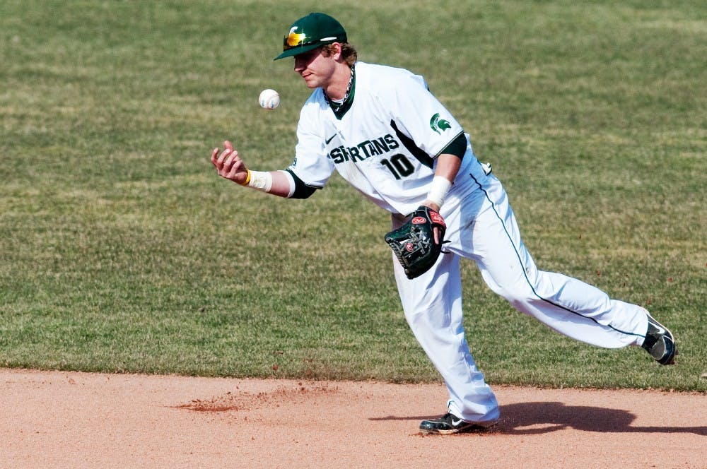 Redshirt sophomore second baseman Ryan Jones bobbles the ball which ended up landing on the ground in the Spartans' 3-1 loss to Central Michigan on Wednesday at McLane Stadium at Kobb Field. Josh Radtke/The State News