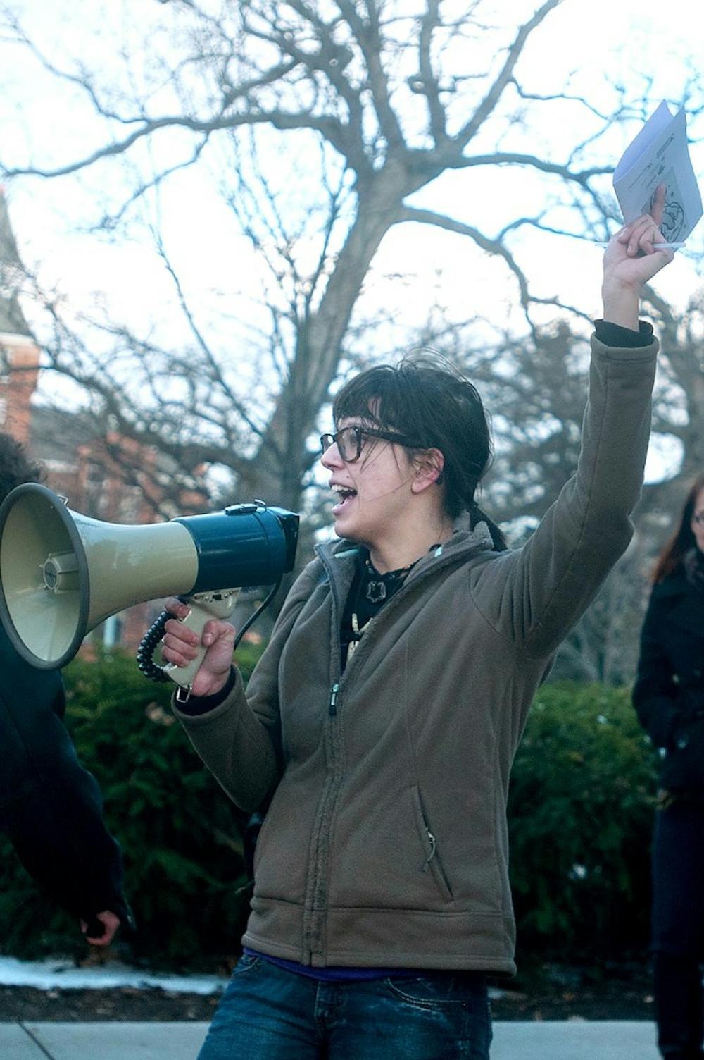 <p>MSU alumna Rachel Berzack yells into a megaphone on April 15, 2014, at Beaumont Tower before marching to the state Capitol as part of "Take Back the Night." The event focuses on eliminating sexual violence. Betsy Agosta/The State News</p>