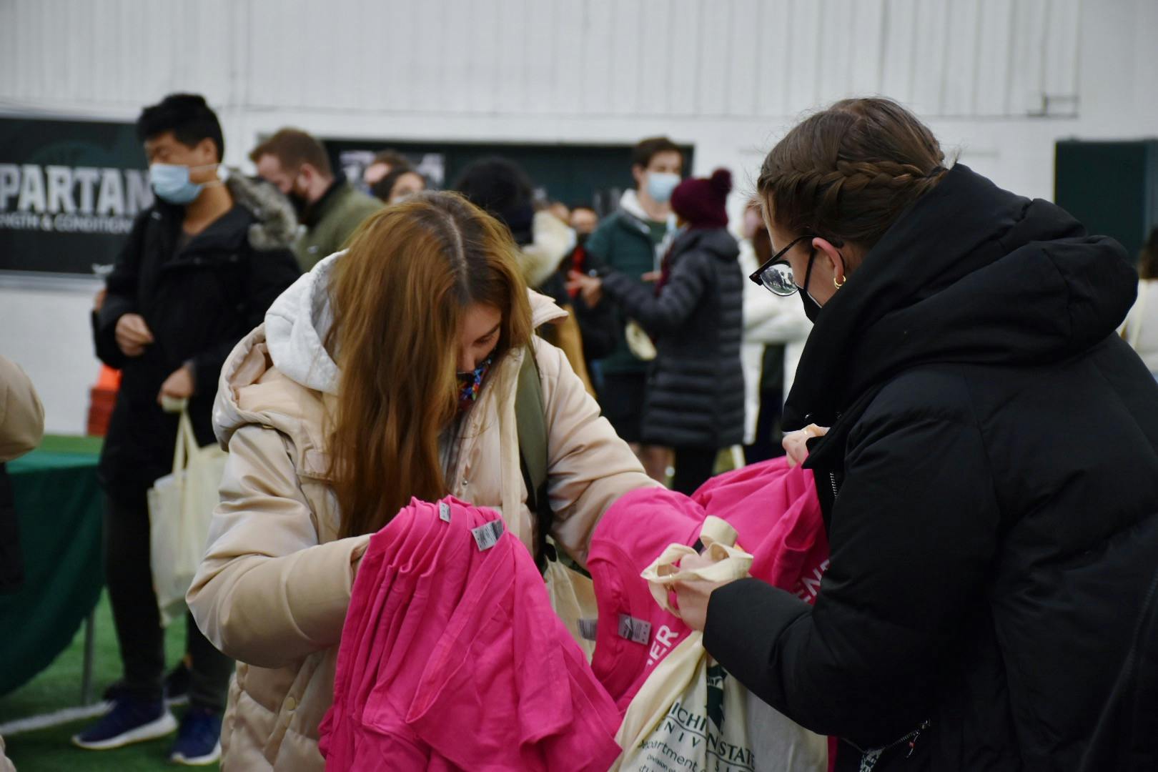 <p>Michigan State student picks up T-shirt provided by The Gender and Sexuality Campus center on Jan. 19, 2022. </p>