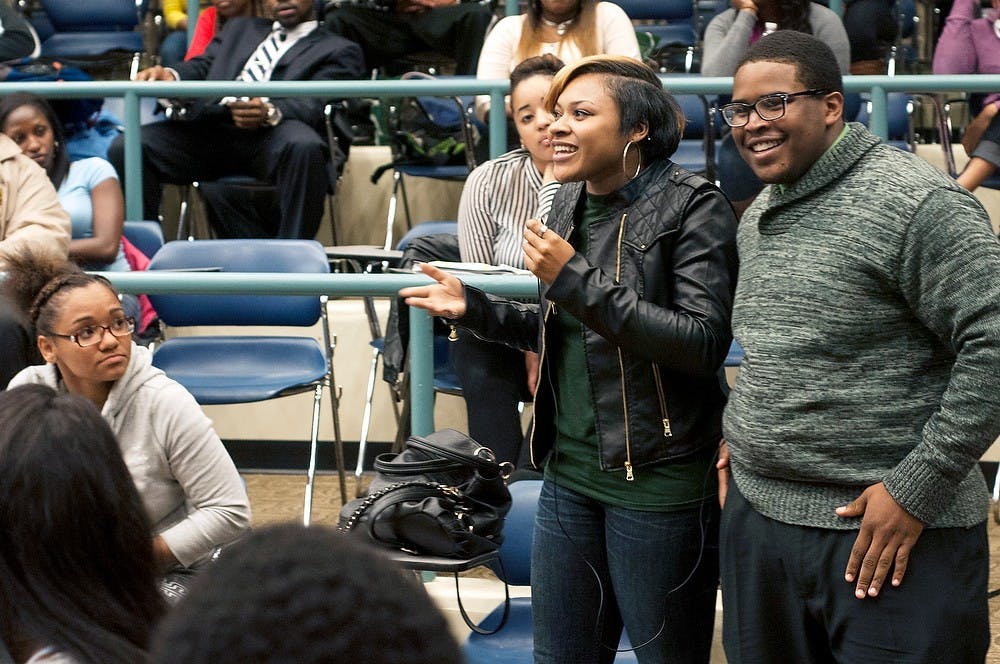 	<p>Kinesiology junior Marjorie Norwood and social work senior Carl Anderson discuss who they go to when they need help Sept. 17, 2013, at the Ignore the Noise event at Erickson Hall. The event focused on how to ignore negative things happening around them to move forward in their lives. Margaux Forster/The State News</p>