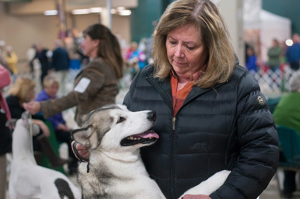 	<p>Grand Rapids resident Karen Succop pets her dog Alice, an Alaskan malamute, during the Ingham County Kennel Club Winterland Classic Dog Show on Dec. 1, 2013, at the Pavilion for Agriculture and Livestock Education. Brian Palmer/The State News</p>