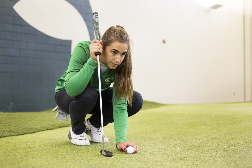 Business-preference freshman Paz Marfasans practices at the indoor golf course on April 4, 2017 at Lasch Family Golf Center in Lansing.  "It's pretty different from back home but I love it. The fact that I'm on a team makes me feel like family, without a team would have made my adaptation to America and the school so much more difficult." Marfasans said. Marfasans is a student from Barcelona Spain who came to Michigan State in August of 2016 to play golf.