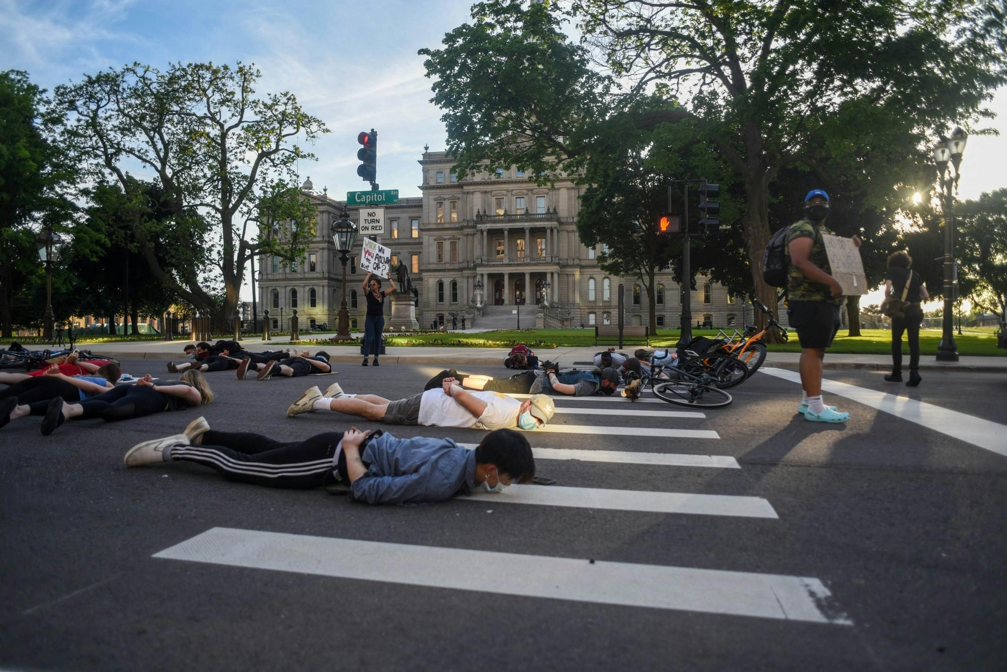 <p>Protesters lay on the ground at a protest around downtown Lansing on June 3, 2020.</p>