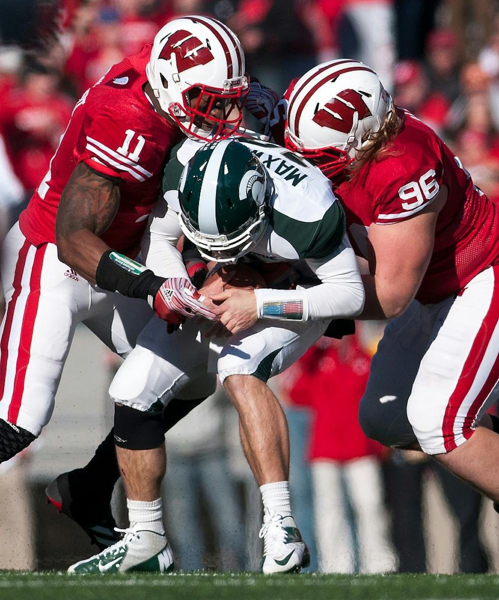 Wisconsin defensive linemen David Gilbert, left, and Beau Allen sack junior quarterback Andrew Maxwell at the second quarter. Michigan State trails Wisconsin, 7-3, on Saturday afternoon, Oct. 27, 2012, at Camp Randall Stadium in Madison, Wisc. at the half. Justin Wan/The State News