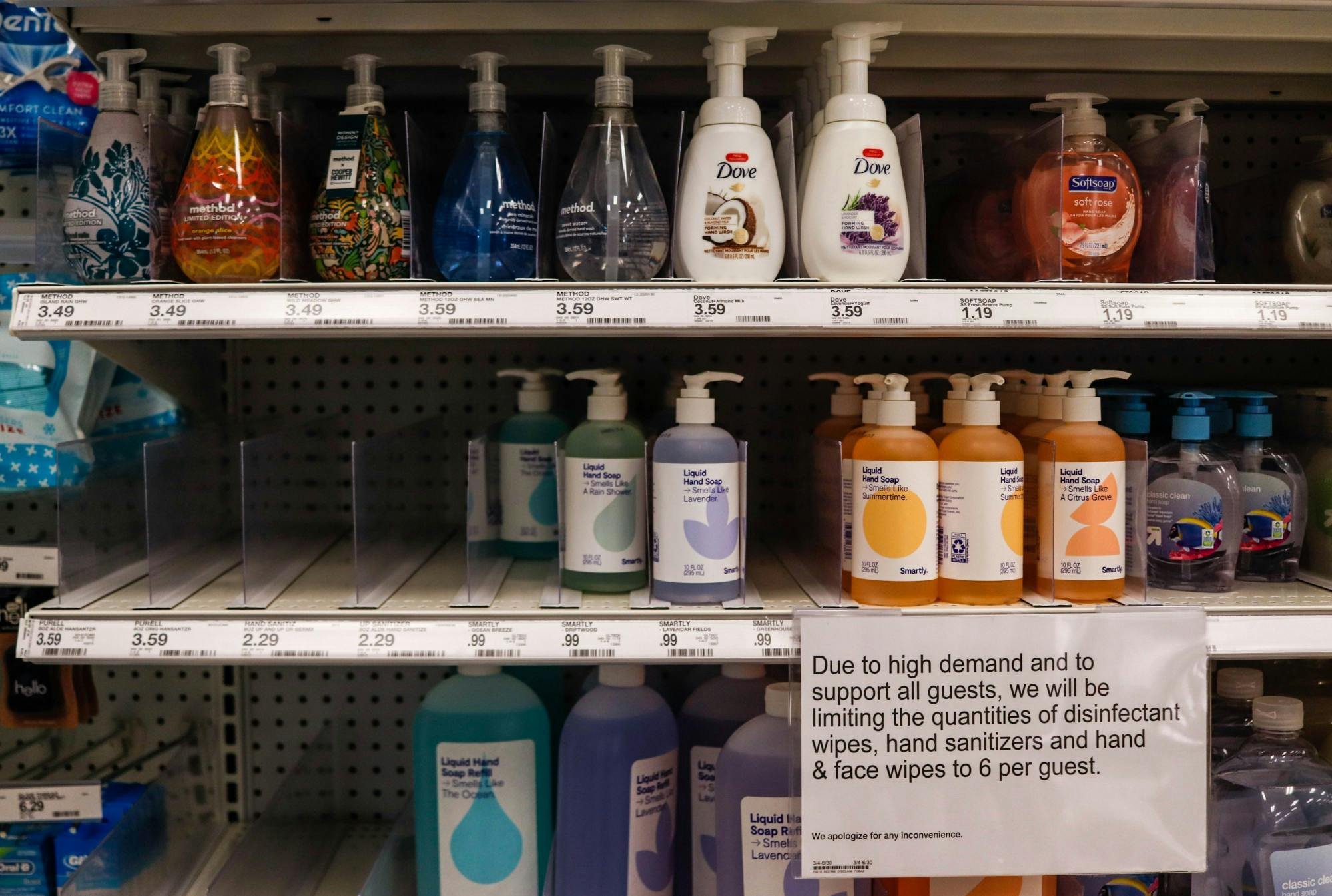 Bottles of soap and hand sanitizer sit on grocery store shelves.