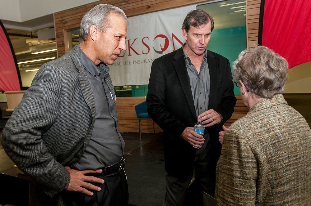 	<p>Jackson National Life VP of Corporate Communications Matt Gonring, left, and President and <span class="caps">CEO</span> Mike Wells, middle, speak with <span class="caps">MSU</span> President Lou Anna K. Simon on Monday. Khoa Nguyen/The State News</p>