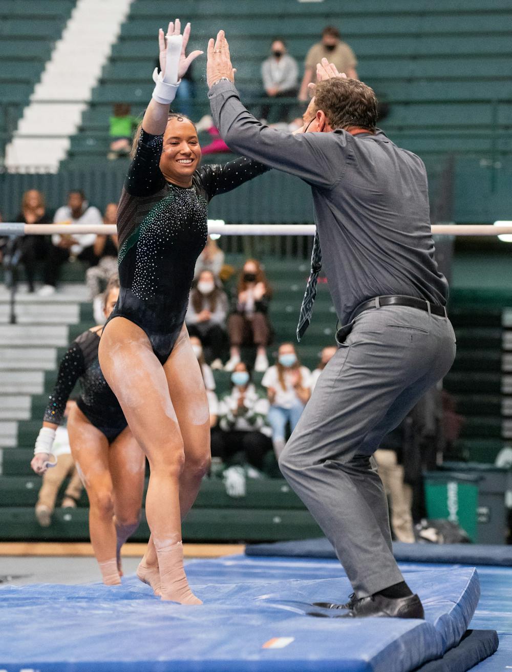<p>Michigan State&#x27;s freshman Skyla Schulte celebrates with Head Coach Mike Rowe after the uneven bars event during Michigan State&#x27;s win over Western on March 5, 2022.</p>