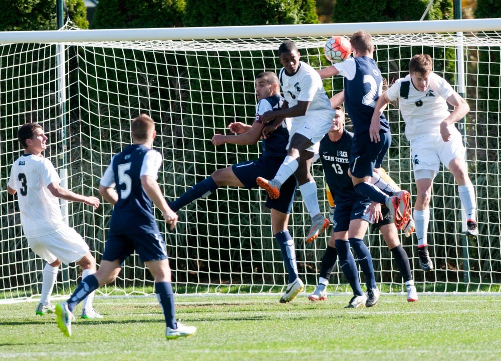 <p>Freshman forward DeJuan Jones and Penn State forward Sam Bollinger jump to head the ball during the Men's Soccer game against Penn State on Oct. 18, 2015 at the DeMartin Soccer Complex. The Spartans defeated the Nittany Lions, 2-1. </p>